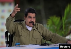 FILE - Venezuela's President Nicolas Maduro speaks during his weekly broadcast "Los Domingos con Maduro" (The Sundays with Maduro) in Caracas, Venezuela, Aug. 6, 2017.