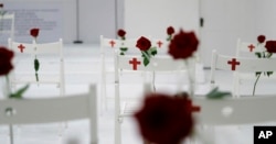 A memorial for the victims of the shooting at Sutherland Springs First Baptist Church, including 26 white chairs each painted with a cross and and rose, is displayed in the church, Nov. 12, 2017, in Sutherland Springs, Texas.