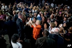 Democratic presidential candidate Hillary Clinton takes a photo with a member of the audience after speaking at a rally at Osceola Heritage Park, in Kissimmee, Fla., Aug. 8, 2016.