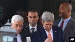 Palestinian President Mahmoud Abbas, left, and U.S. Secretary of State John Kerry walk after their meeting in Amman Jordan, Sunday, Feb. 21, 2016.