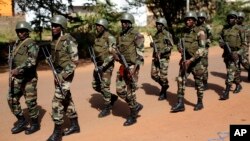 FILE - Soldiers from the presidential guard patrol outside the Radisson Blu hotel in Bamako, Mali, Nov. 21, 2015.