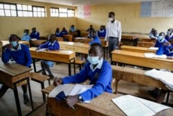 Schoolchildren attend class at the Olympic Primary School in Kibera, one of the capital Nairobi's poorest areas, Oct. 12, 2020. Kenya partially re-opened schools to allow those students due for examinations which had been postponed to prepare.