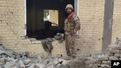An army soldier examines damages on the site of a bombing at a police station on the outskirts of Dera Ismail Khan, Pakistan, Dec. 12, 2023.