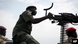 FILE - A government soldier mans a vehicle-mounted machine gun in the oil-rich town of Malakal, South Sudan.