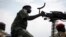 FILE - A government soldier mans a vehicle-mounted machine gun in the oil-rich town of Malakal, South Sudan.