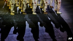 FILE - Saudi soldiers are seen during a parade marking Saudi 89th National Day celebrations in Riyadh, Saudi Arabia, Sept. 21, 2019. The U.S. is in the process of deploying air defense systems and troops to the kingdom.