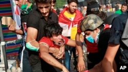 An injured protester is rushed to a hospital during clashes between Iraqi security forces and demonstrators, in Baghdad, Iraq, Nov. 14, 2019.