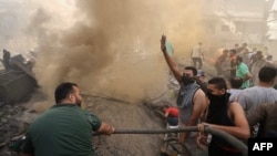 Palestinians go through the rubble of a building in Khan Yunis on November 6, 2023, amid the ongoing battles between Israel and the Palestinian group Hamas. (Photo by Mahmud HAMS / AFP)