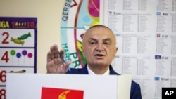 FILE - Albanian President Ilir Meta gestures as he votes during parliamentary elections in the capital Tirana, Albania, April 25, 2021.