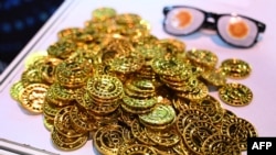 FILE - A photo illustration of bitcoin is seen at consensus, the flagship event of Coindesk and the data platform for the global crypto economy, at the Convention and Exhibition Centre in Hong Kong on Feb. 19, 2025.