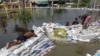 Thailand Bows to Flood Surge, Says Gates Must Open
