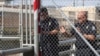 U.S. Customs and Border Protection officers reopen the border gate of the Gateway International Bridge that connects downtown Matamoros, Mexico with Brownsville, Texas, Oct. 10, 2019.
