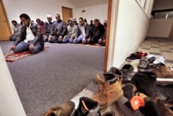 FILE - Muslim worshippers pray inside a makeshift mosque above a convenience store and market that caters to Somalis in Fort Morgan, Colo., Jan. 8, 2016.