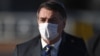 Le président brésilien Jair Bolsonaro portant un masque avant une réunion ministérielle au Palais Alvorada à Brasilia, pendant la pandémie de coronavirus, le 12 mai 2020. (Evaristo Sa/AFP)