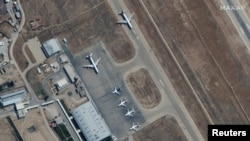 FILE - Several commercial airplanes are seen near the main terminal of the Mazar-i-Sharif airport, in northern Afghanistan, Sept. 3 2021. (Maxar Technologies/Handout via Reuters).