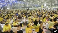 Anti-government protesters listen to the speech of a leader, unseen, during their protest at Suvarnabhumi international airport in Bangkok, Thailand, Nov. 25, 2008