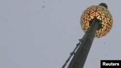 FILE - The Tiimes Square New Year's Eve ball is seen at One Times Square building during a test run before the official New Year's Celebration at Times Square in Manhattan, New York, Dec. 30, 2017.