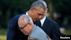 U.S. President Barack Obama (L) hugs atomic bomb survivor Shigeaki Mori as he visits Hiroshima Peace Memorial Park in Hiroshima, Japan, May 27, 2016.