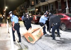 Debris is thrown at police during a demonstration Tuesday night, Oct. 27, 2020, in Philadelphia.