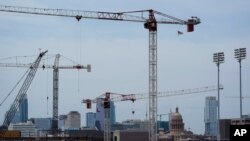 Construction cranes hover over downtown and near the State Capitol, April 26, 2021, in Austin, Texas. The latest census numbers will give the southwestern state two additional seats in the U.S. House.