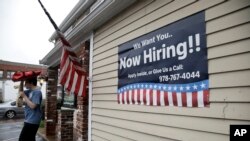 A sign advertising employment hangs outside a restaurant in Middleton, Massachusetts, July 24, 2017.