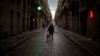 A man walks along an empty street in downtown Barcelona, Spain, March 26, 2020 as the lockdown to combat the spread of coronavirus continues. 