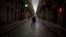 A man walks along an empty street in downtown Barcelona, Spain, March 26, 2020 as the lockdown to combat the spread of coronavirus continues. 