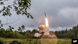 FILE - This photo provided Sept. 19, 2017, by the Russian Defense Ministry website shows a Russian missile launched during a military exercise near St. Petersburg, Russia. The U.S. has told Russia to dismantle missiles that Washington claims violate a 1987 nuclear arms treaty.