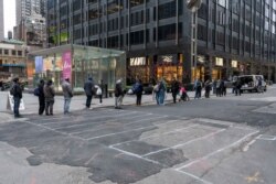 Keeping their distance from each other, New Yorkers line up to pick up food packages provided by New York Cares volunteers. (Photo by New York Cares)