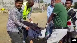 In this image made from video, medics carry the victim of an airstrike in Mekele, capital of the Tigray region of northern Ethiopia, Sept. 14, 2022.