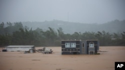 A home is submerged in floodwaters caused by Hurricane Fiona in Cayey, Puerto Rico, Sept. 18, 2022.