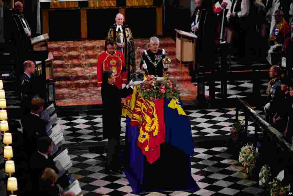 The Imperial State Crown is removed from the coffin during the Committal Service for Queen Elizabeth at St. George's Chapel, at Windsor Castle, Sept. 19, 2022.
