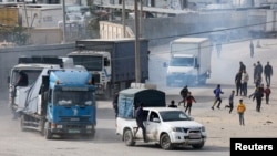Trucks carrying aid arrive, amid the ongoing conflict between Israel and the Palestinian Islamist group Hamas, in Rafah in the southern Gaza Strip Jan. 17, 2024. 
