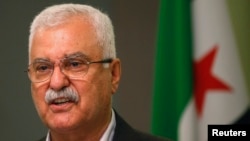 FILE - George Sabra, a veteran Christian opposition figure and acting President of the Syrian National Coalition, speaks during a news conference in Istanbul, May 13, 2013.