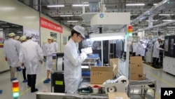 FILE - A phone production line is pictured at a Huawei factory in Dongguan, China, March 6, 2019. China's state media this week announced Chinese electrical appliance manufacturer Midea Group jointly built its first overseas 5G factory in Thailand with Huawei and other firms. 