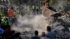 Rescue workers and volunteers search for victims under the rubble of a destroyed building hit in an Israeli airstrike, in Aalmat village, northern Lebanon, Nov. 10, 2024.