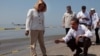 President Barack Obama and Lafourche Parish President Charlotte Randolf, left, inspect a tar ball as they look at the effect the BP oil spill is having on Fourchon Beach in Port Fourchon, Louisiana, May 28, 2010. (Official White House Photo by Chuck Kenne