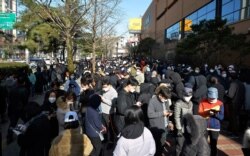 FILE - People line up to buy face masks at a store in Daegu, South Korea, Feb. 24, 2020.