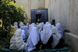 FILE - Afghan students attend an open air class at a primary school in Kabul, Oct. 7, 2020.