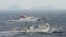 An aerial photo shows Chinese marine surveillance ships Haijian No. 49 (front) and Haijian No.50 cruising in the East China Sea, as the islands known as Senkaku isles in Japan and Diaoyu islands, April 23, 2013.