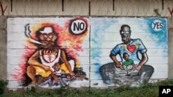 In this photo taken Sunday, Nov. 6, 2016, a mural painted by the Ana Taban, or "I am tired" artists movement, depicting South Sudanese families, is seen in Juba, South Sudan. For many in South Sudan, the arts have become a rare haven of peace in a young country that has known little but years of civil war.