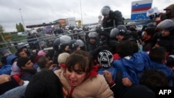 A child cries as migrants cross the Croatia-Slovenia border at Trnovec, Oct. 19, 2015.