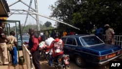 FILE - Security guards check vehicles leaving Nigeria for Cameroon at a border checkpoint in Mfum, in Cross Rivers State, southeast Nigeria, Feb. 1, 2018.