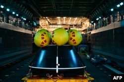 FILE - The Orion crew module test capsule rests in the well deck aboard the USS San Diego at Naval Base San Diego following the Underway Recovery Test 11 in San Diego, California, on Feb. 28, 2024.