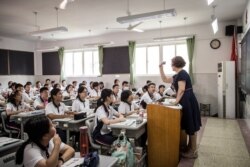 Students attend a class on the first day of the new semester in Wuhan in China's central Hubei province on Sept. 1, 2020.