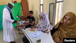 FILE - A man attends voting at a polling station during presidential election in Nouakchott, Mauritania, June 22, 2019. 