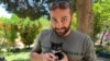 FILE - Reuters visuals journalist Issam Abdallah holds a kitten while posing for a picture in Saaideh, Lebanon, July 4, 2023.