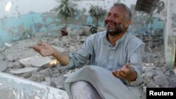 A man cries in front of houses destroyed during a recent Syrian Air Force air strike in Azaz, about 47 kilometers north of Aleppo, Syria, August 15, 2012.