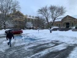 Students go about their lives during the pandemic lockdown on the campus of the University of King’s College in Halifax, Nova Scotia. (Jay Heisler/VOA)