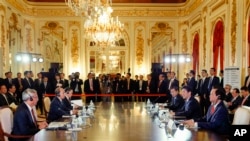 Japanese Prime Minister Shinzo Abe, right center, delivers his opening speech at the Japan-Mekong Summit Meeting on the sidelines of Japan-ASEAN Commemorative Summit in Tokyo, Dec. 14, 2013. 